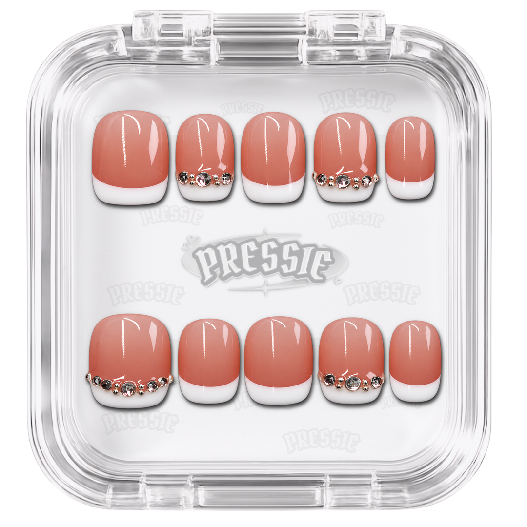 Faux ongles nude à French blanche et motifs argentés, présentés dans leur boîte Pressie Nails — Hanni. @product
